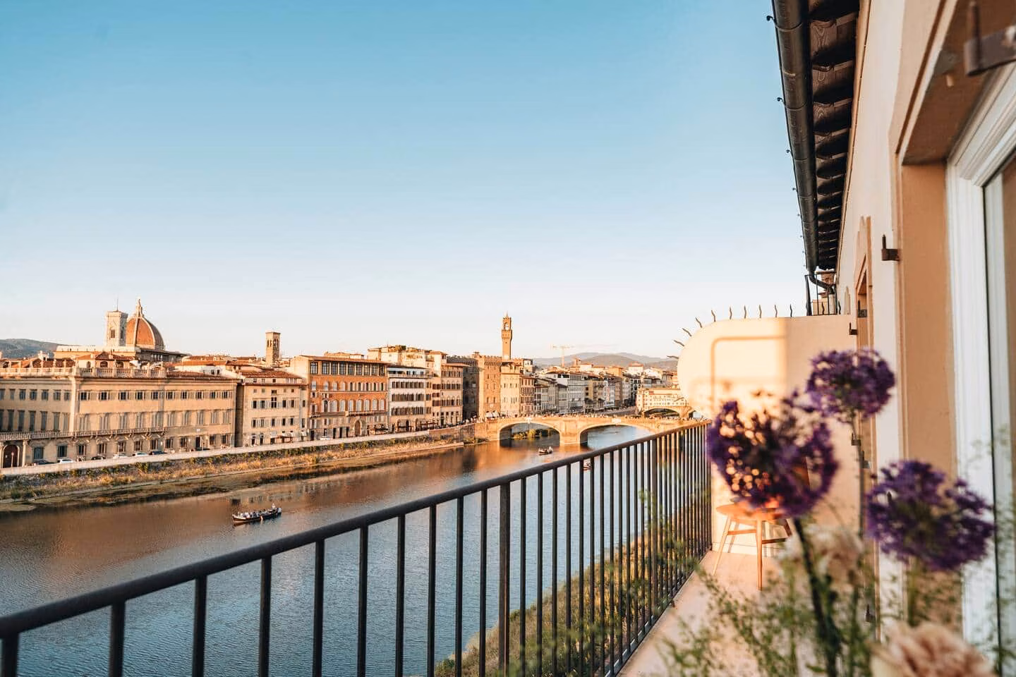 Luxury View Arno — golden-hour balcony over the Arno with the Duomo and Ponte Vecchio