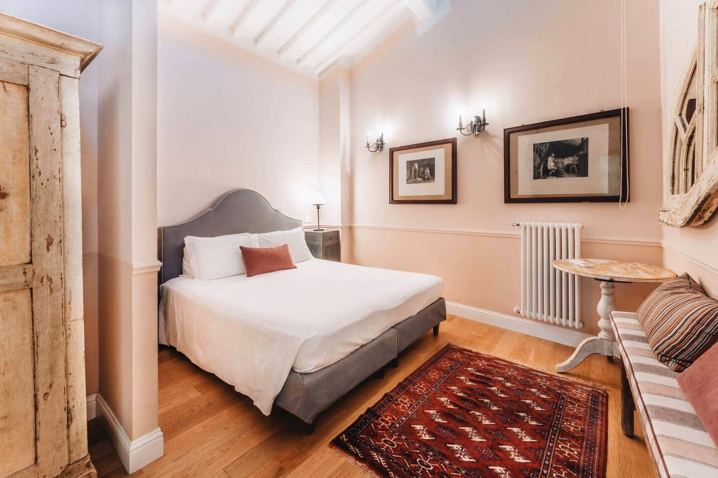 Il Bue Terrace Apartment — double bedroom beneath exposed timber beams with a wide oak plank floor