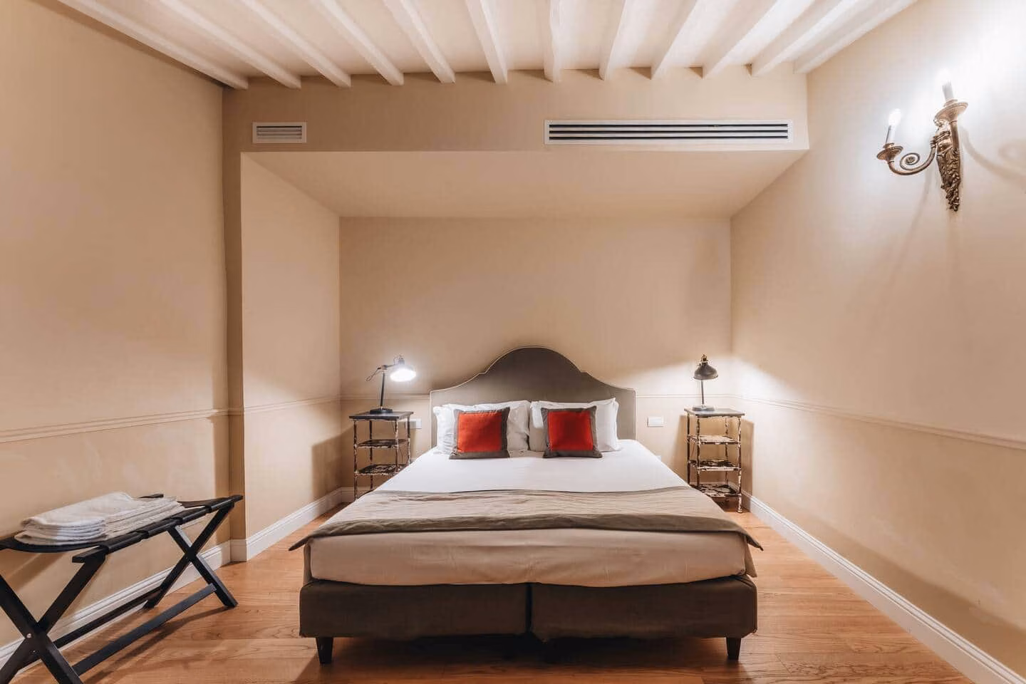 Le Ruote — double bedroom with exposed white-painted ceiling beams