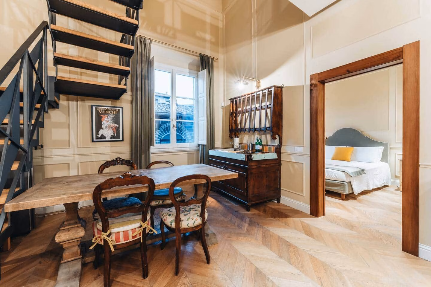 Le Ruote — dining area with a rustic wood table and antique chairs