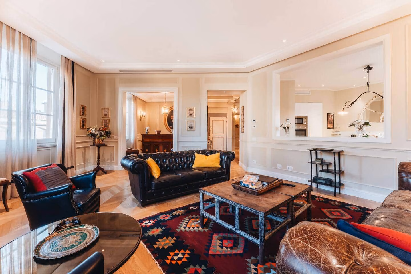 Luxury Suite — living room with Chesterfield leather sofas and herringbone parquet