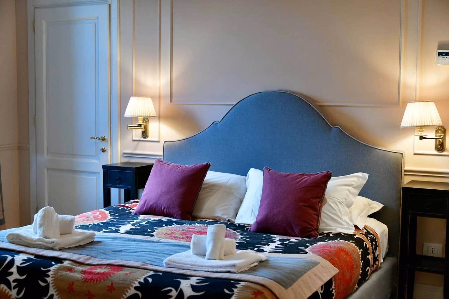 Luxury Suite — double bedroom with an upholstered blue headboard